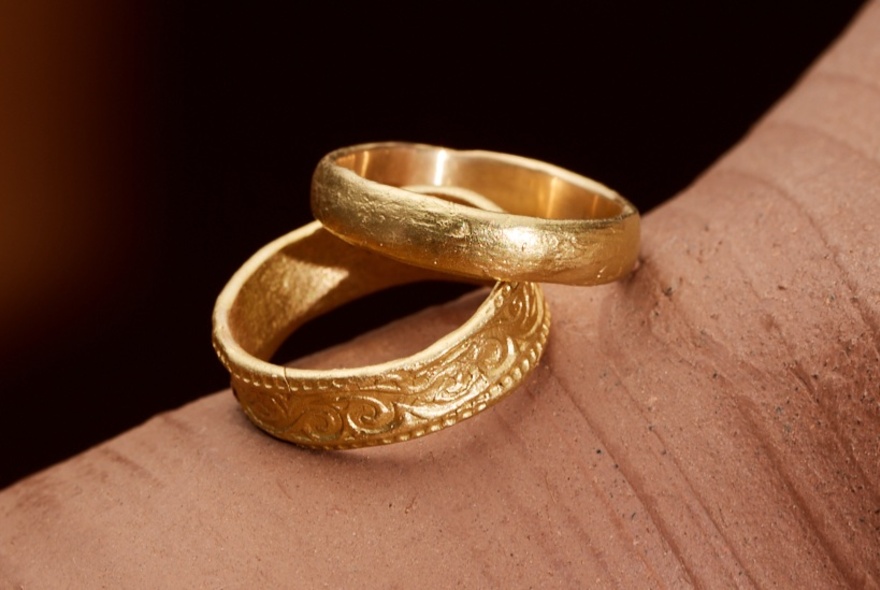 Two textured gold wedding bands. 