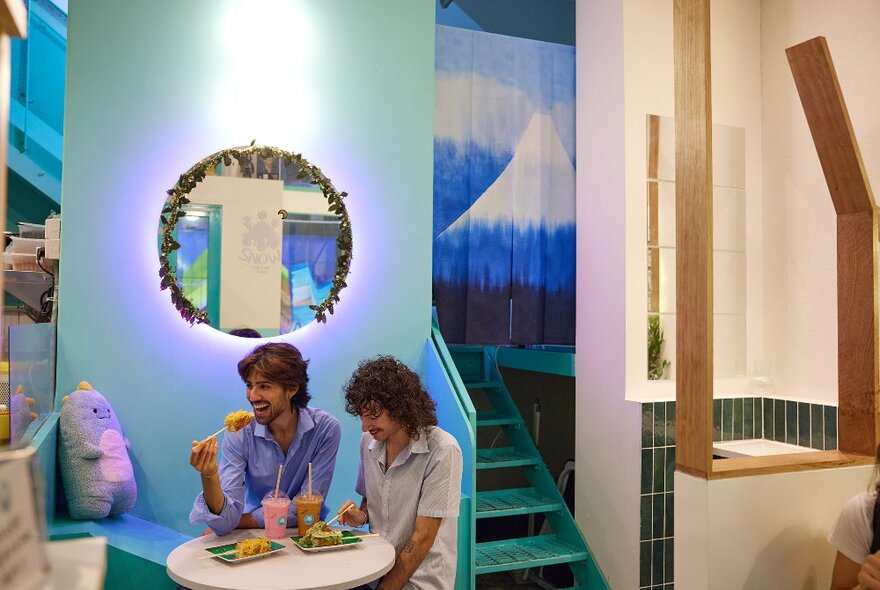 A couple are eating desserts in a cafe