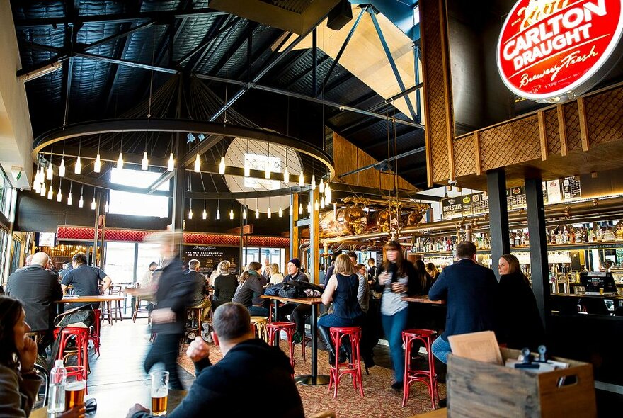 Interior of The General Assembly, a busy bar with a large light feature.