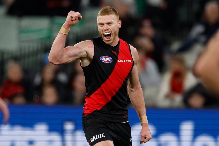 Peter Wright celebrating for Essendon on the footy field 