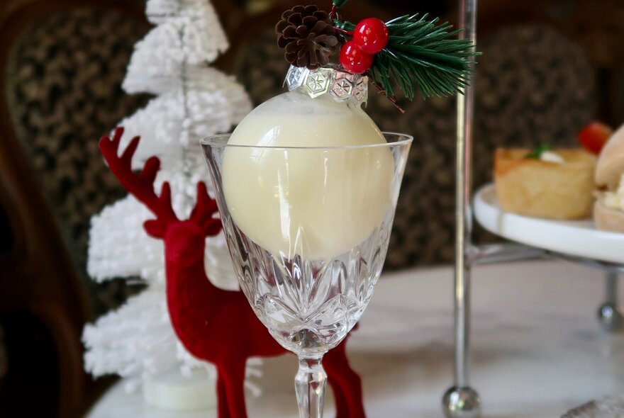 A red deer and silver Christmas tree next to a snowball-themed cocktail.