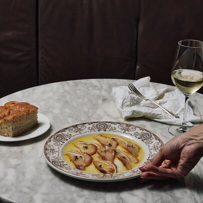 A table with ceviche, focaccia and wine.