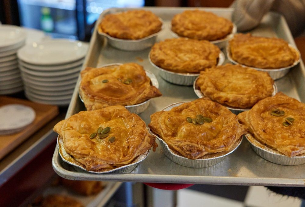 Silver baking tray of pies.
