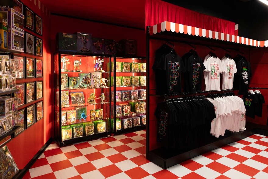 Exhibition space with checkerboard floor and merchandise on shelves.