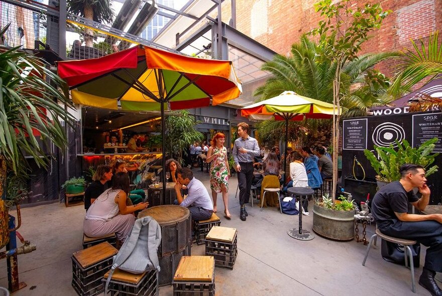 Two people strolling in a laneway bar.