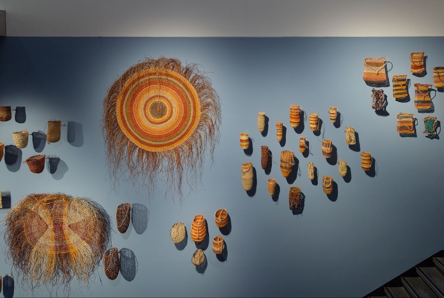 Installation view of an exhibition in a gallery featuring works by Aboriginal and Torres Strait Islander artists