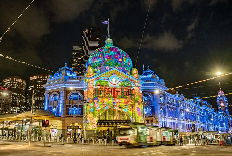 Flinders Street Station lit up with Christmas projections. 