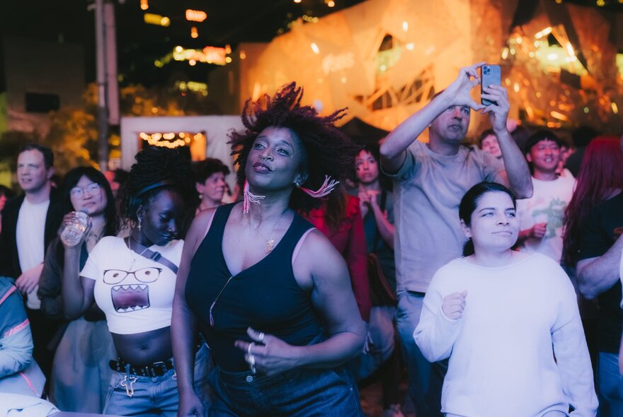 Revellers enjoying an open air live performance at Melbourne's Fed Square.