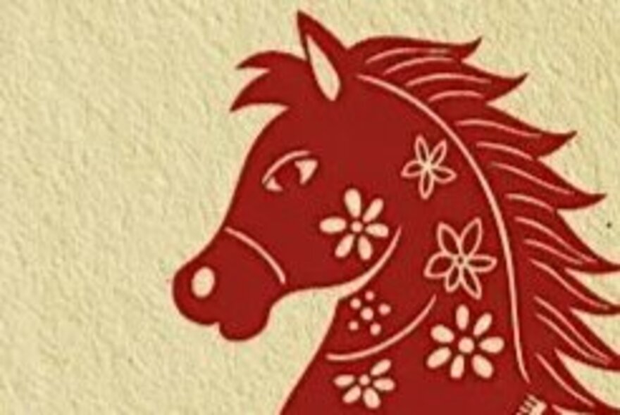 A screen-printed red horse on raw paper signifying the Chinese Year of the Horse.
