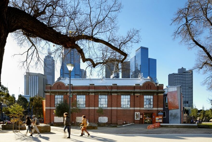 Double-storey ArtPlay building with city skyscrapers in the background.