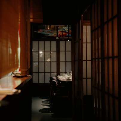 A dimly lit Japanese restaurant with traditional sliding doors.