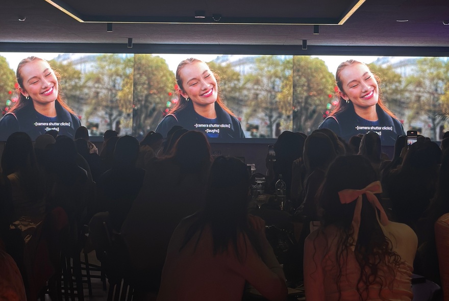 Three side-by-side television screens showing the same scene from a television show and being watched by an audience of women.