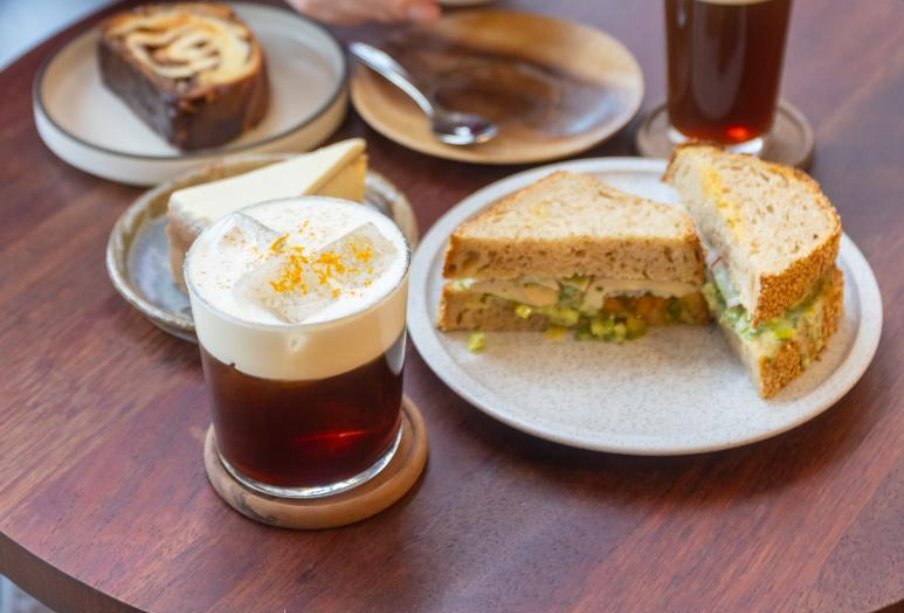 Creamy beverage next to a sandwich