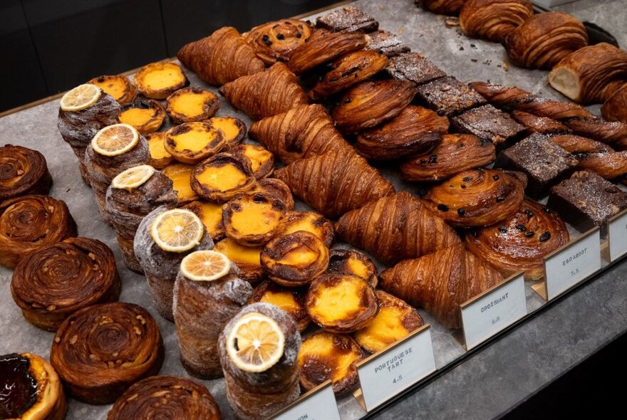 Polished concrete display shelf covered in pastries.