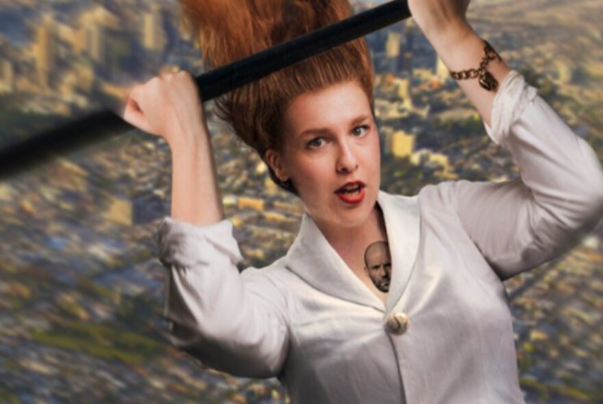 Woman wearing a white shirt, balancing her hands on an overhead beam.