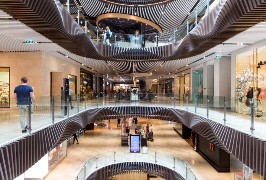 A view of several levels of Emporium Melbourne shopping centre with geometric architecture.
