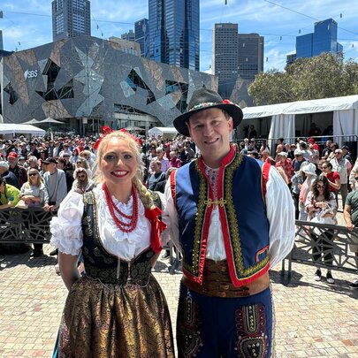 A couple in Polish traditional dress in Federation Square.