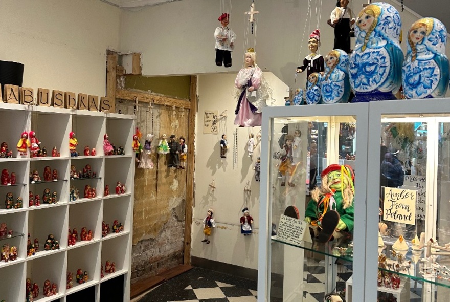 Retail store shelves displaying Eastern European dolls and puppets.