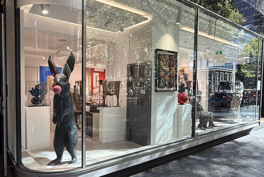 The display window of the French-originated Gallery Got, with a large bronze standing rabbit in the corner.