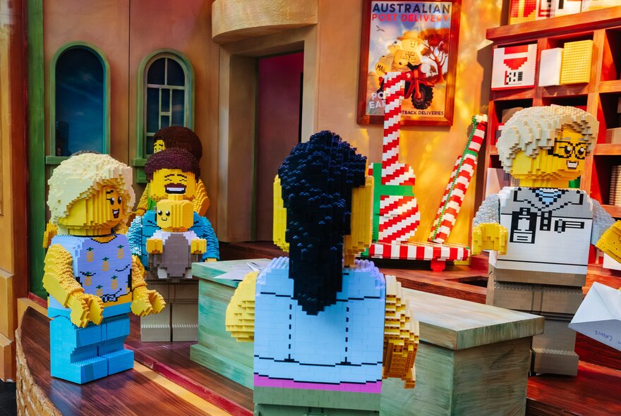 A Christmas scene with a family at the post office, all made from LEGO.