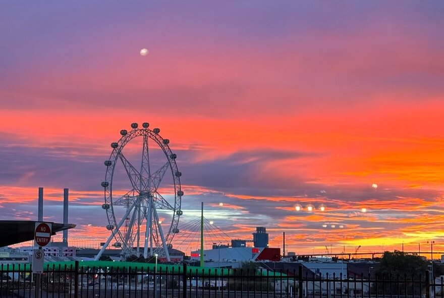 Sunset Docklands view with carousel and Bolte Bridge.