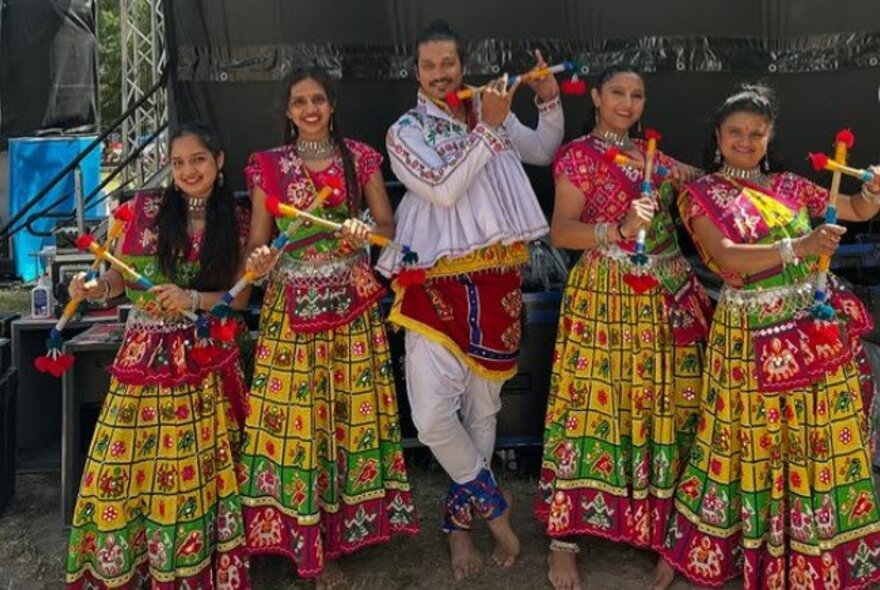 A five-person Sri Lankan band, each member wearing a colourful traditional costume.