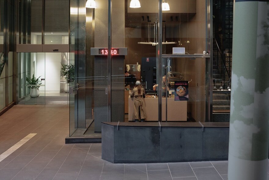 Shop frontage with glass windows in a mall space.