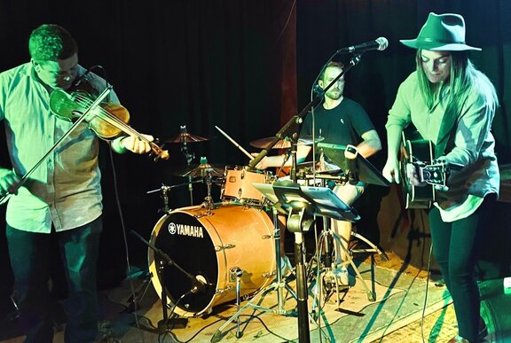 A band playing live music on a small stage.