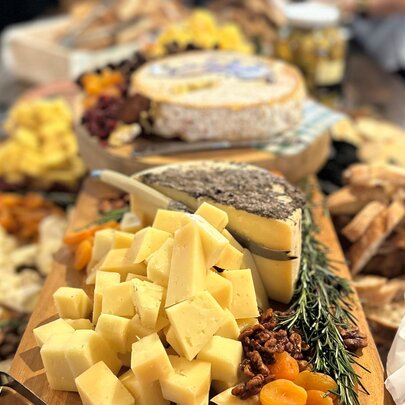 A long cheese board with a variety of cheeses on offer. 