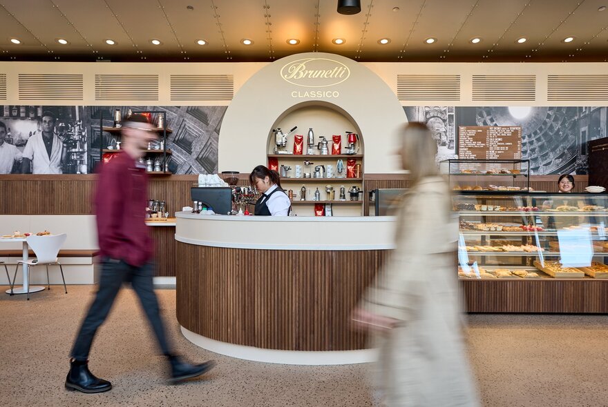 People in blurred motion past a Brunetti Classico pop-up shop