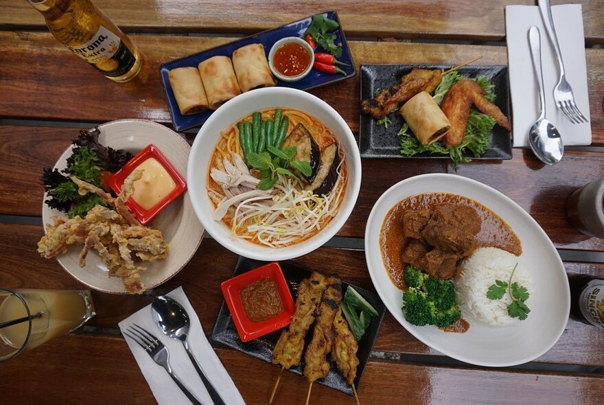 Malaysian meal with noodles, satay and chicken wings.