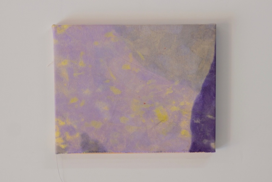 An abstract artwork of pale colours and splotches of yellow, hanging on a gallery wall.