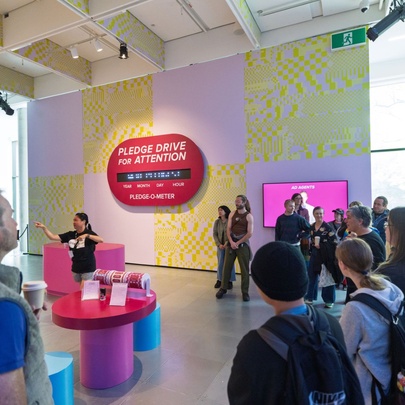 People gathered in an exhibition space with displays.
