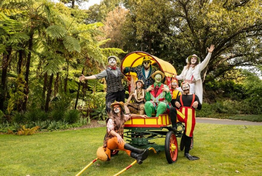 A group of actors dressed as Wind in the Willows characters posed inside a cart in the Royal Botanic Gardens.