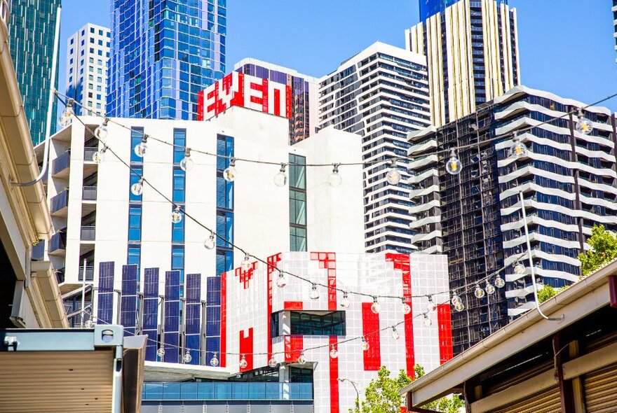 City buildings showing large scale public artwork spelling out words on the facade.