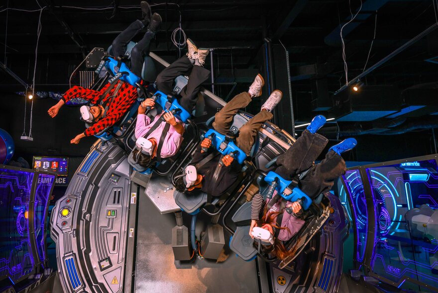 Children strapped in upside-down while riding a high-tech VR game.