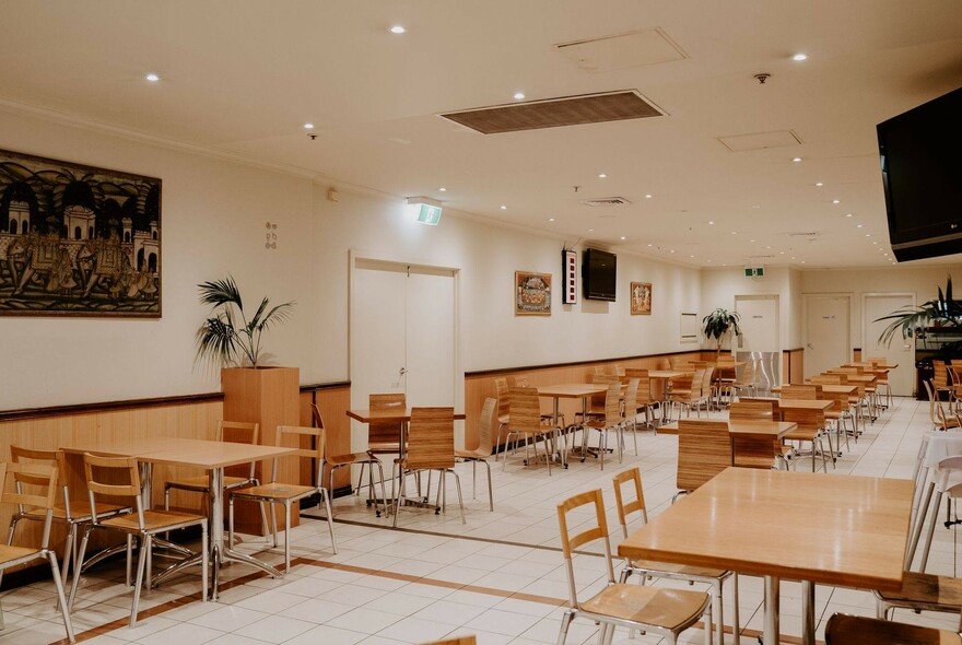 Interior of Flora: clean, light and bright space with simple wooden table and chairs.