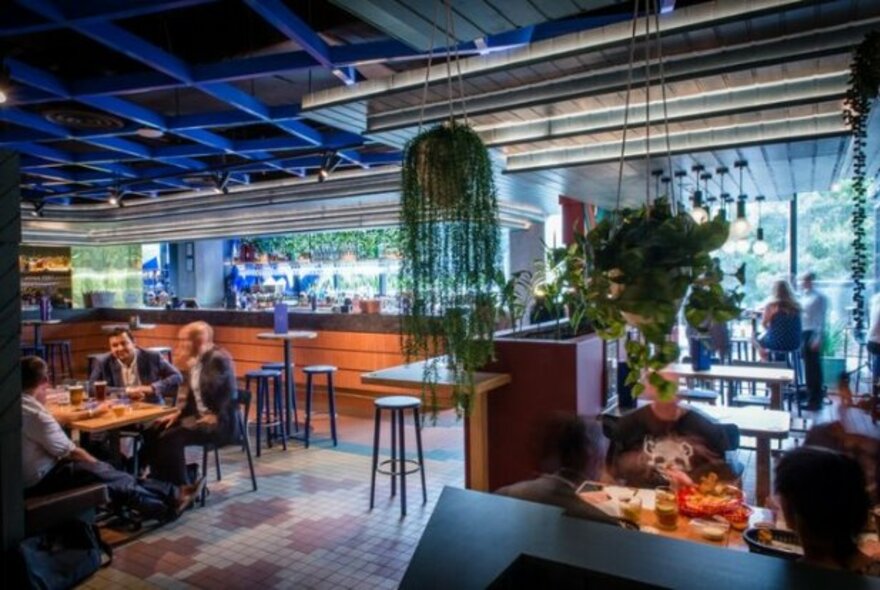 People seated enjoying drinks in a bar.