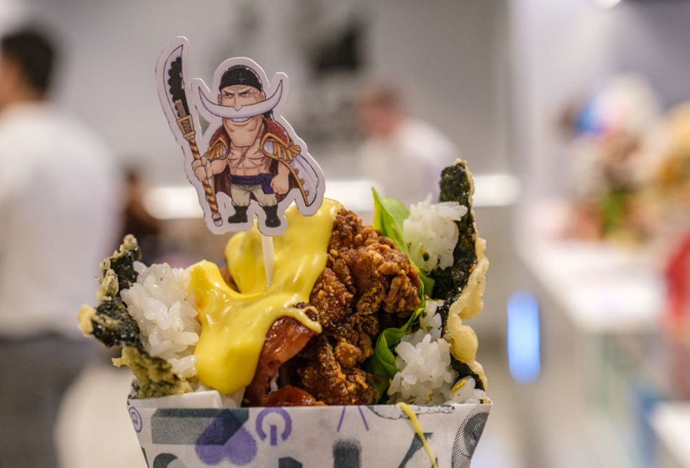 A fried chicken burger with a little cartoon cut out on top