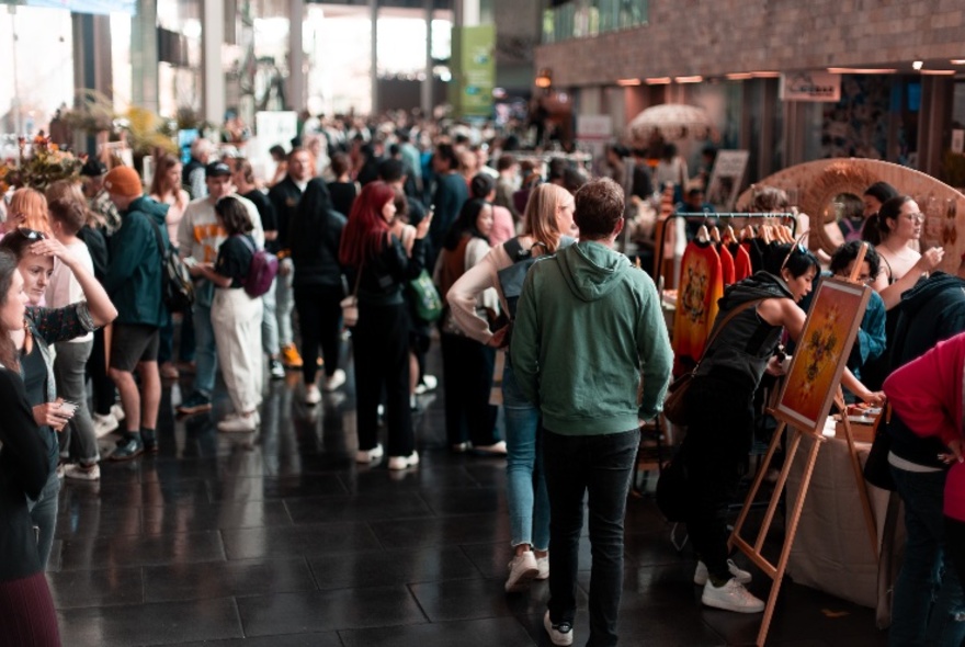 People gathered at an indoor market. 
