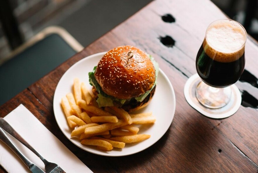 Burger, chips and a drink in a glass. 