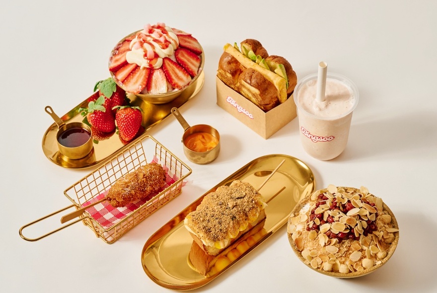 A selection of delicious Korean desserts, artfully presented on gold servingware.