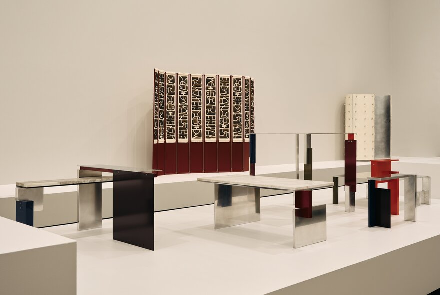 Creative design artworks displayed in a white gallery setting.