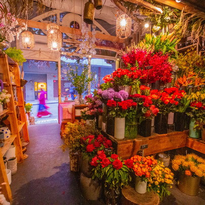 A colourful display of flowers in a shop.
