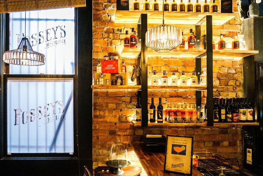 A dimly lit bar with bottles of alcohol on the shelf