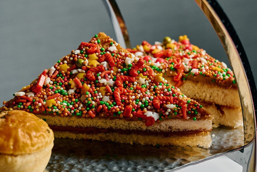 Christmas-themed fairy bread nutella sandwiches on a silver platter.