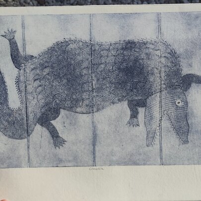 Hand holding a printed image of an animal.