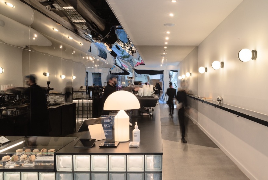 Interior of Bench Coffee Co showing long espresso bar counter and glass display cabinets.