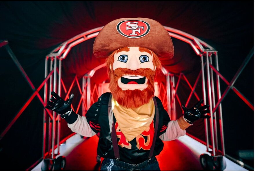 49ers mascot, a red-bearded man with a yellow bandana and hat.