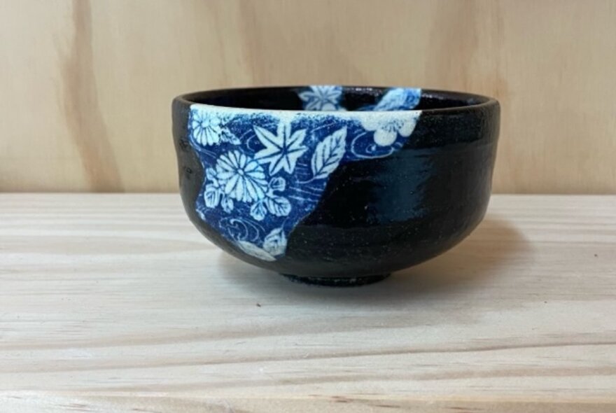 A black and blue ceramic patterned bowl.